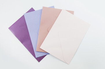 gift delicate envelopes of violet, pink colors. set of assorted envelopes. gift on a white background. give gifts for the holidays. write letters. celebrate . background for blog, article, bigboard.
g