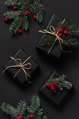 Christmas composition with wrapped presents, fur branches and red berries. Festive holiday concept.