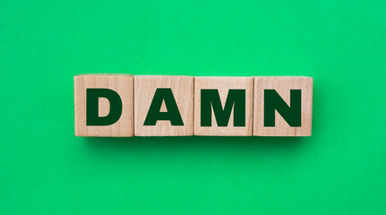 Damn word made with building blocks isolated on green