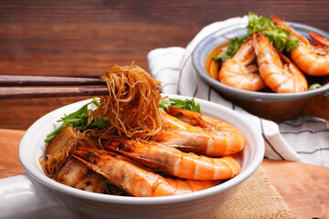 Prawns and pork belly, baked vermicelli with coriander, spring onions and chives, Asian food, in a cup with handle