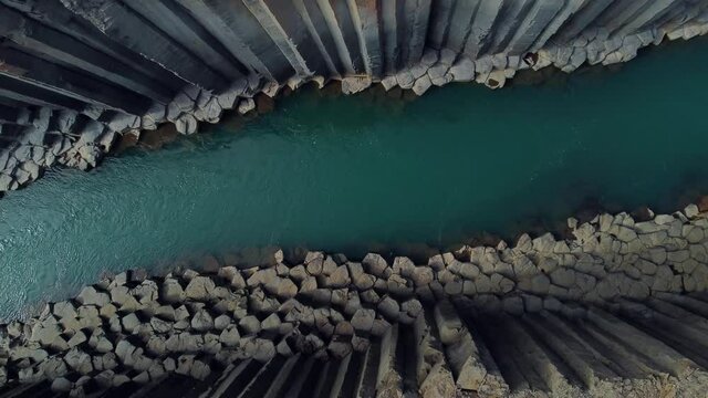 Studlagil canyon in iceland. Basalt columns. Aerial drone video of Icelandic landscape. Famous tourist attractions and landmarks destinations in Icelandic nature on Iceland. 4K UHD video.