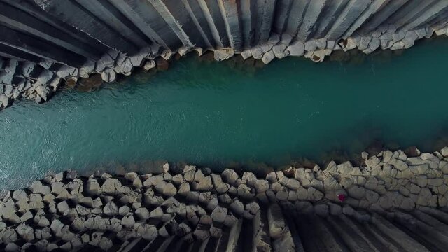 Studlagil canyon in iceland. Basalt columns. Aerial drone video of Icelandic landscape. Famous tourist attractions and landmarks destinations in Icelandic nature on Iceland. 4K UHD video.