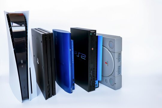 Bangkok, Thailand - February 28, 2021 : Playstation Sony game console hardware 1, 2, 3, 4 and 5 placed vertically and arrange on white background.