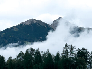 Big clouds before two mountains