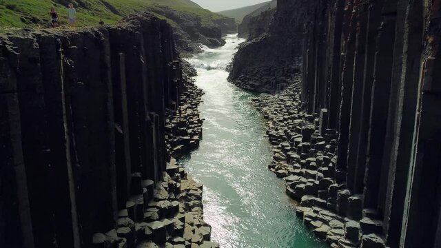 Studlagil canyon in iceland. Basalt columns. Aerial drone video of Icelandic landscape. Famous tourist attractions and landmarks destinations in Icelandic nature on Iceland. 4K UHD video.