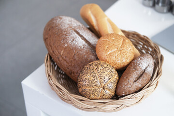 Homemade for Bakery and golden crusty breads in basket on the top of counter in the kitchen