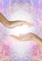 Sensing healing energy coming from palm chakra - female open hand hovering over another open hand...