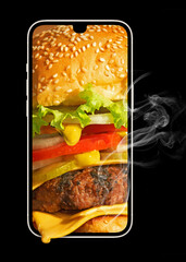 Food delivery concept. Ordering food in a smartphone. Burger and phone isolated on black background.