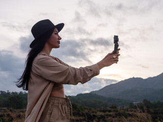 Young woman blogger shoots on an action camera.