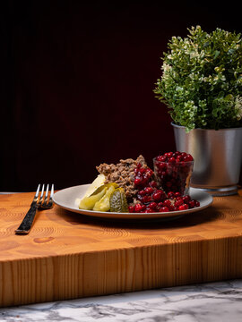Traditional Finnish cuisines; closeup of saut&eacute;ed reindeer on a plate with lingonberry jam and pickles on the side.