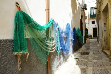 Fish net hunged on the wall in a Mazara del Vallo narrow street, Trapani, Sicily, Italy