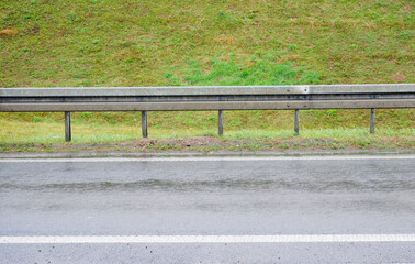 Traffic barrier and green grass