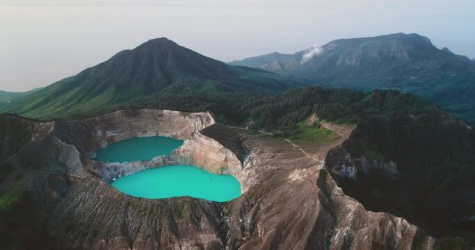 Volcano mountain blue water crater lakes. Aerial flight over turquoise aqua in Kelimutu volcanic mount. Nature background. Travel destination. Beautiful wild landscape. Crater lakes in Ende, Indonesia