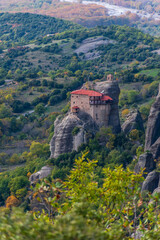 Fototapeta na wymiar Agios Nikolaos monastery, an unesco world heritage site, located on a unique rock formation above the village of Kalambaka during fall season. 