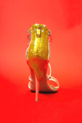 Creative party concept with female high heels. Golden glitter concept.  