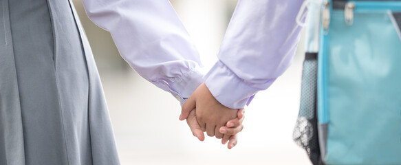 Rear view of children student friend holding hands each other go back to school. Back to School...