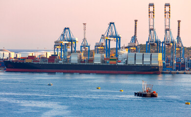 A large container ship is loaded in the cargo port of Malta.