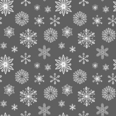 Winter seamless pattern with hand drawn snowflakes. Decorative Christmas background. Vector illustration.