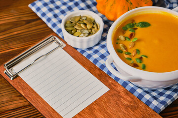 Homemade pumpkin soup with cream and basil