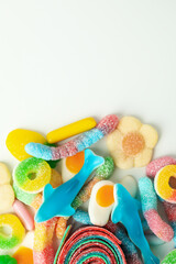 Fototapeta na wymiar Gummy candies on white background, space for text