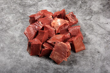Raw sliced beef heart on black background. Top View 