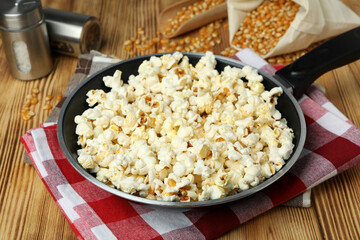 Concept of homemade popcorn on wooden background