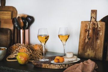 Two elegant glasses of Orange or Amber wine and appetizers