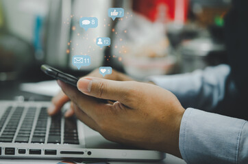 Obraz na płótnie Canvas businessman holds a phone and uses social media for internet marketing. Concept of business technology