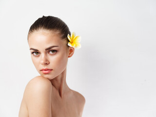 Fototapeta na wymiar pretty woman with flower in hair naked shoulders isolated background