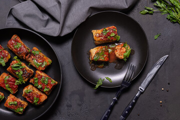 Flat lay with ready to eat stuffed cabbage rolls on black background