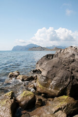 Fototapeta na wymiar Picturesque Black Sea coastline near Koktebel resort with huge boulders in the foreground, Crimea, Russia
