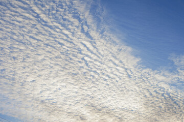 Spindrift white clouds on blue sky