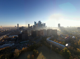 a panoramic view of the city business skyscrapers in the morning fog at sunrise filmed from a drone 