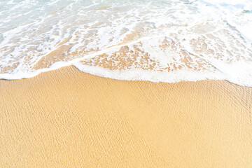 Clear sand beach and wave foam on the  beach with copy space for background