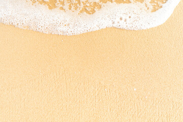 Clear sand beach and wave foam on the  beach with copy space for background