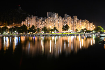 City of Ploce and Adriatic sea in Croatia by night. Panoramic view of  buildings in town reflected in the water. 