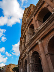 Fototapeta premium Roman Colosseum against a Blue Cloudy Sky