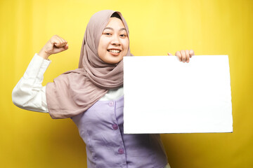 Pretty young muslim woman cheerful holding blank empty banner, placard, white board, blank sign...
