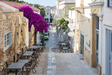 Fototapeta na wymiar Hermoupolis city cafe bar cobblestone street at capital of Syros island Cyclades destination Greece