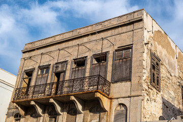 Part of damaged abandoned stonewall house at Ermoupolis capital of Syros island Cyclades Greece.