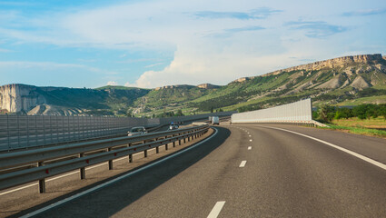 Car traffic on a winding highway in mountainous area