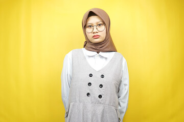 Beautiful asian young muslim woman looking at camera isolated on yellow background