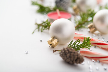 Christmas and New Year composition on a white background. Christmas tree branches, cones, candles,...