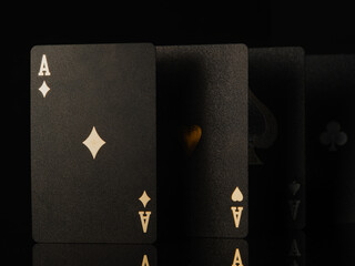 Poker game. Black cards with gold lettering on a black background. There are no people in the...