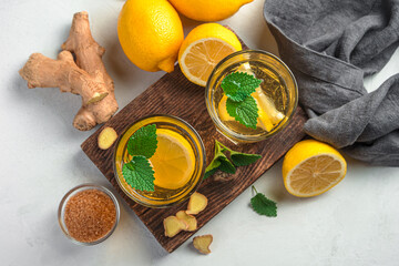 Tea with lemon and ginger on the background of ingredients.