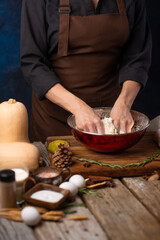 The chef kneads the dough for a traditional American pumpkin pie. Ingredients. decor. Thanksgiving, harvest holiday, Halloween, family holidays.