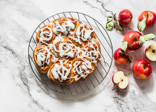 Cinnamon apples rolls - delicious autumn dessert on a light background, top view