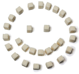 Cubes of white sugar in a smile pose, isolated on a white background.
