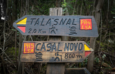 PR4 and PR5 LSA (Lousa) regional footpaths - wooden signpost pointing the way and distances to Talasnal and Casal Novo Schist Villages, Lousa, Portugal