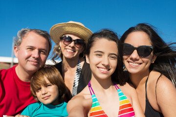 Portrait of family at beach. Happy relatives looking at camera, smiling. Family, vacation, outdoor activity concept